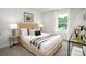 Well-lit bedroom featuring carpet flooring, a large window, and a stylish upholstered bed at 140 Falling Up Ln, Salisbury, NC 28147