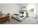 Bright bedroom featuring a neutral color scheme, desk, and natural light from the window at 140 Falling Up Ln, Salisbury, NC 28147