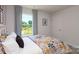 Bright bedroom featuring a scenic backyard view and patterned curtains at 146 Falling Up Ln, Salisbury, NC 28147