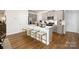 Spacious kitchen with gray cabinets, quartz countertops, stainless steel appliances, and a large island at 146 Falling Up Ln, Salisbury, NC 28147