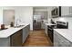 Modern kitchen featuring gray cabinets, stainless steel appliances, and a spacious island with a white countertop at 146 Falling Up Ln, Salisbury, NC 28147