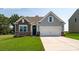Charming single-Gathering home showcasing a manicured lawn, stone accents, and an attached two-car garage at 152 Falling Up Ln, Salisbury, NC 28147