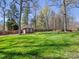 Spacious backyard features a well-maintained lawn, mature trees, and a storage shed at 153 Stafford Estates Dr, Salisbury, NC 28146