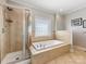Bathroom featuring a glass shower and a separate soaking tub at 153 Stafford Estates Dr, Salisbury, NC 28146