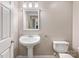 Half bathroom with a pedestal sink and toilet at 153 Stafford Estates Dr, Salisbury, NC 28146