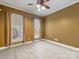 This bedroom has plush carpet, neutral walls, a ceiling fan, and large windows at 153 Stafford Estates Dr, Salisbury, NC 28146