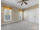 Bedroom featuring carpet, a double closet and two large windows at 153 Stafford Estates Dr, Salisbury, NC 28146