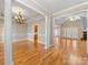 Spacious dining room featuring hardwood floors, detailed trim, a chandelier, and an open layout at 153 Stafford Estates Dr, Salisbury, NC 28146
