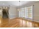 Bright dining room featuring hardwood floors, large windows, and staircase at 153 Stafford Estates Dr, Salisbury, NC 28146