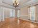 Dining room with hardwood floors, natural light, elegant chandelier and access to other living spaces at 153 Stafford Estates Dr, Salisbury, NC 28146