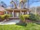 Inviting front porch with brick columns, decorative bushes, and a clear view of the front door at 153 Stafford Estates Dr, Salisbury, NC 28146