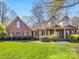Charming brick home featuring a well-manicured lawn, covered porch and mature landscaping at 153 Stafford Estates Dr, Salisbury, NC 28146