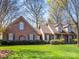 Beautiful brick home with a lush green lawn, shutters, and a welcoming covered front porch at 153 Stafford Estates Dr, Salisbury, NC 28146
