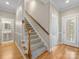 Hallway with hardwood floors leading to carpeted stairs and an open doorway at 153 Stafford Estates Dr, Salisbury, NC 28146