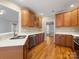 Well-lit kitchen features wood cabinets, stainless steel appliances and hardwood floors at 153 Stafford Estates Dr, Salisbury, NC 28146