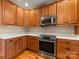 This kitchen features wooden cabinets, stainless steel appliances, and white countertops at 153 Stafford Estates Dr, Salisbury, NC 28146