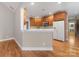 Bright kitchen area with wooden cabinets, white appliances, and hardwood flooring at 153 Stafford Estates Dr, Salisbury, NC 28146
