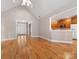 Spacious living room featuring hardwood floors, an open floor plan, and view of kitchen at 153 Stafford Estates Dr, Salisbury, NC 28146