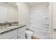 Bathroom with granite vanity and tub/shower combo with white tile surround and fixtures at 1530 Doran Ter, Richburg, SC 29729