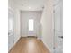 Bright entryway with a white door, light wood floors, and access to the staircase at 1530 Doran Ter, Richburg, SC 29729
