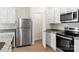 Modern kitchen featuring stainless steel appliances, a granite countertop, and access to a pantry at 1530 Doran Ter, Richburg, SC 29729