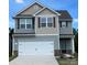 Two-story home featuring a two-car garage, stone accents, and coordinated gray and tan siding at 1564 Doran Ter, Richburg, SC 29729
