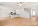 Open concept living room with white walls, light floors, and view of kitchen at 1564 Doran Ter, Richburg, SC 29729