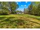 Spacious grassy backyard with the house and some trees in the background at 1725 Bristol Rd, Statesville, NC 28677