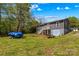 Spacious backyard with lush lawn, picnic table and grey home in the background at 1725 Bristol Rd, Statesville, NC 28677