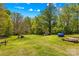 Expansive, level backyard with mature trees offering privacy and shade at 1725 Bristol Rd, Statesville, NC 28677