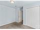 Cozy bedroom features neutral carpet, closet, and light blue walls at 1725 Bristol Rd, Statesville, NC 28677
