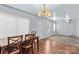 Dining area with wood floors, a chandelier, and adjacent living room at 1725 Bristol Rd, Statesville, NC 28677