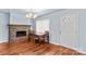 Dining area with hardwood floors, a stone fireplace, and a classic chandelier for an inviting atmosphere at 1725 Bristol Rd, Statesville, NC 28677