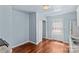 A view of the kitchen leading to a back door with a white refrigerator and hardwood floors at 1725 Bristol Rd, Statesville, NC 28677