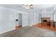 Open living room featuring neutral carpet and hardwood flooring leading to dining area with a stone fireplace at 1725 Bristol Rd, Statesville, NC 28677