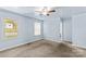 Cozy bedroom with soft blue walls, neutral carpet, a window, and access to an adjacent bathroom at 1725 Bristol Rd, Statesville, NC 28677