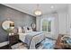 Comfortable bedroom with a decorative rug, wallpapered accent wall, and a large window with sheer curtains at 19329 Watermark Dr # 531, Cornelius, NC 28031