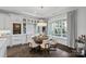 Open-concept dining area with modern chandelier, large windows, and built-in bar, perfect for entertaining at 19329 Watermark Dr # 531, Cornelius, NC 28031