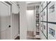 A hallway with a hidden closet with decor and photos, adding character and storage space at 19329 Watermark Dr # 531, Cornelius, NC 28031