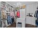 Organized walk-in closet with custom shelving, ample storage space, and a deluxe laundry basket at 19329 Watermark Dr # 531, Cornelius, NC 28031
