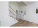 Bright foyer boasts high ceilings, a staircase with wooden handrail, and a view of the front door at 202 Westerwood Dr, Rock Hill, SC 29732
