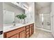 The stylish bathroom features double sinks, wood cabinets, a large mirror, and a glass shower at 2023 Aragon Ln, Gastonia, NC 28056