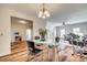 Bright dining area showcasing hardwood floors, a glass table, and an open layout at 2023 Aragon Ln, Gastonia, NC 28056