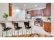 Well-equipped kitchen with stainless steel appliances, cherry cabinets, and a breakfast bar at 2023 Aragon Ln, Gastonia, NC 28056
