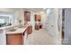 Open-concept kitchen features stainless steel appliances, ample counter space, and warm wood cabinetry at 2023 Aragon Ln, Gastonia, NC 28056