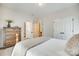 Bright main bedroom featuring a decorative dresser, ensuite, walk-in closets, and a plush bed at 2023 Aragon Ln, Gastonia, NC 28056
