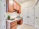 A well-lit office area includes built-in desk, storage cabinets and drawers, and tiled flooring at 2023 Aragon Ln, Gastonia, NC 28056