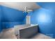 A mostly finished attic with painted blue walls and access to a staircase at 203 Jackson St, Fort Mill, SC 29715