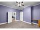 Carpeted bedroom featuring a ceiling fan, two entry doors and a built-in desk at 203 Jackson St, Fort Mill, SC 29715