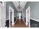 Inviting hallway with hardwood floors, wainscoting, and chandelier, creating a warm and elegant entry at 203 Jackson St, Fort Mill, SC 29715